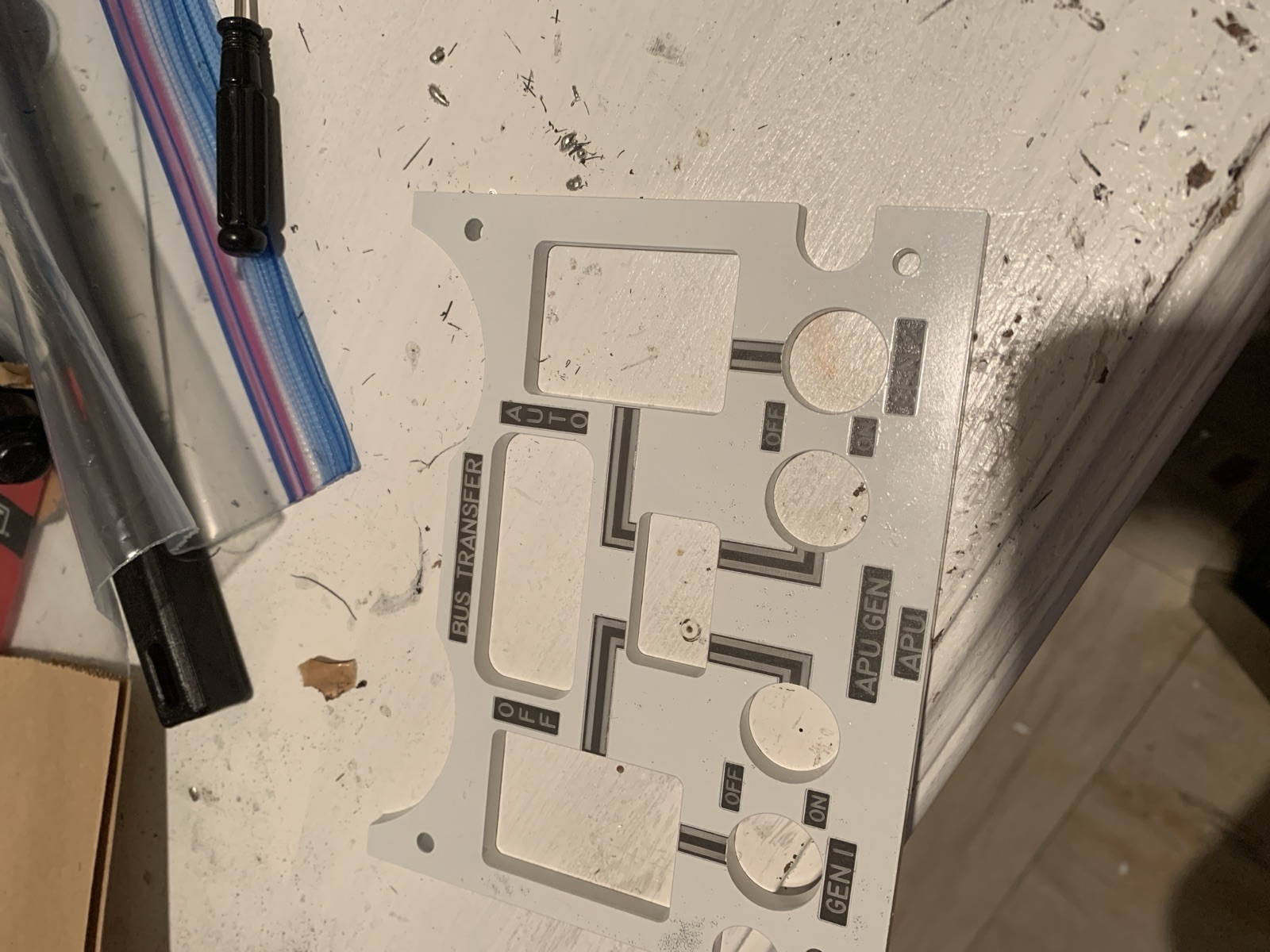 Cut bus panel resting on the workbench showing the switch and knob openings