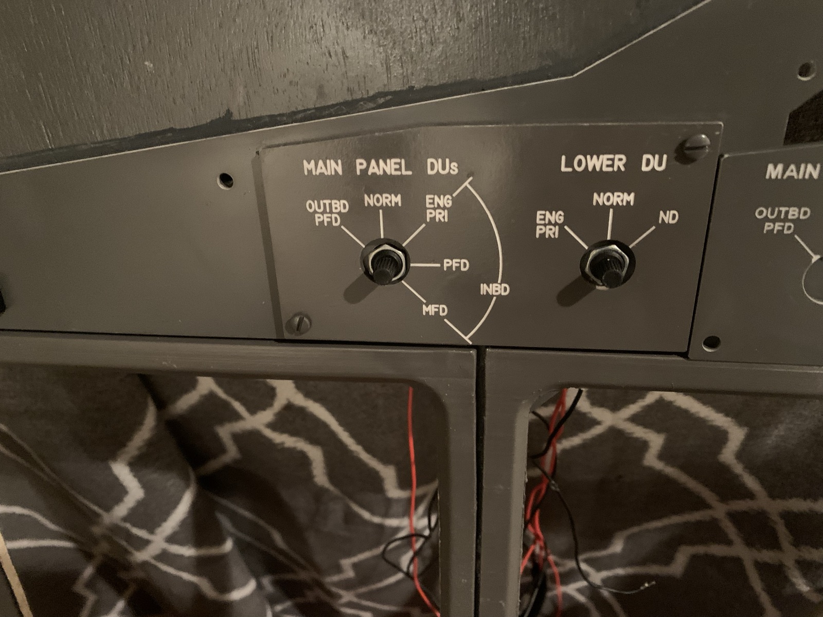 Display unit panel mounted in the cockpit frame with wiring hanging below