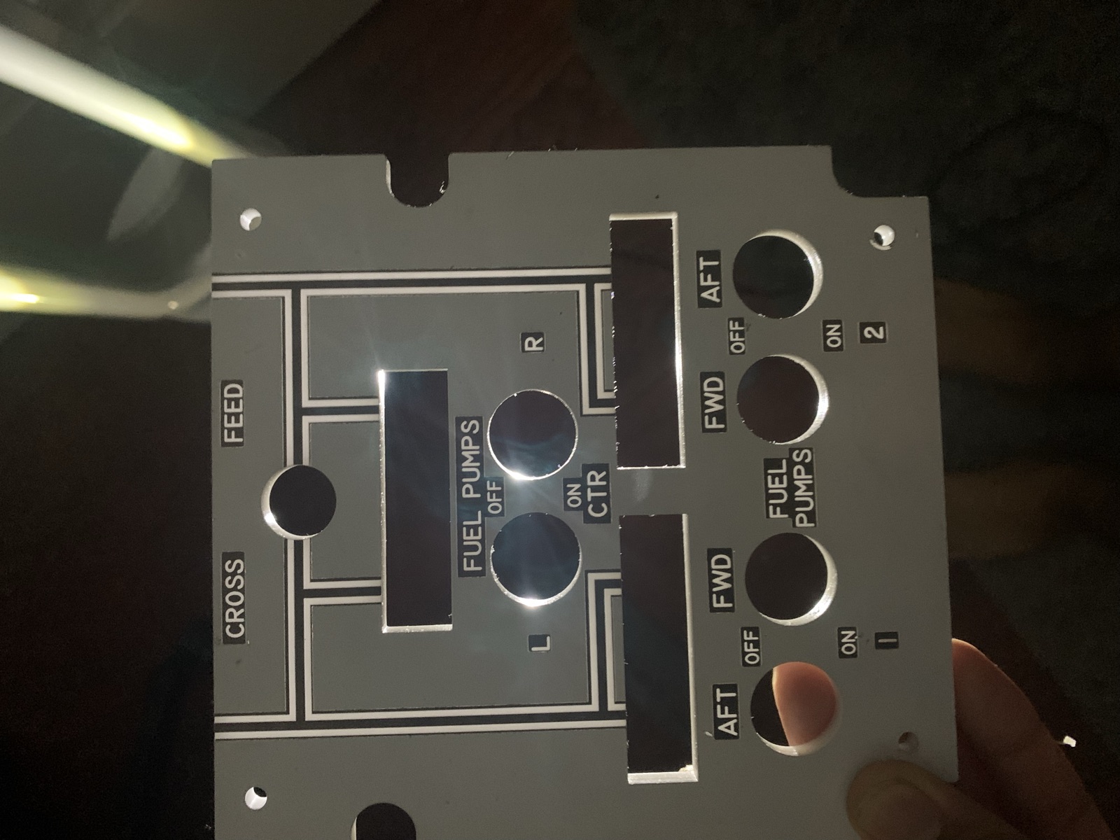 Finished laser cut fuel pump panel face held in hand