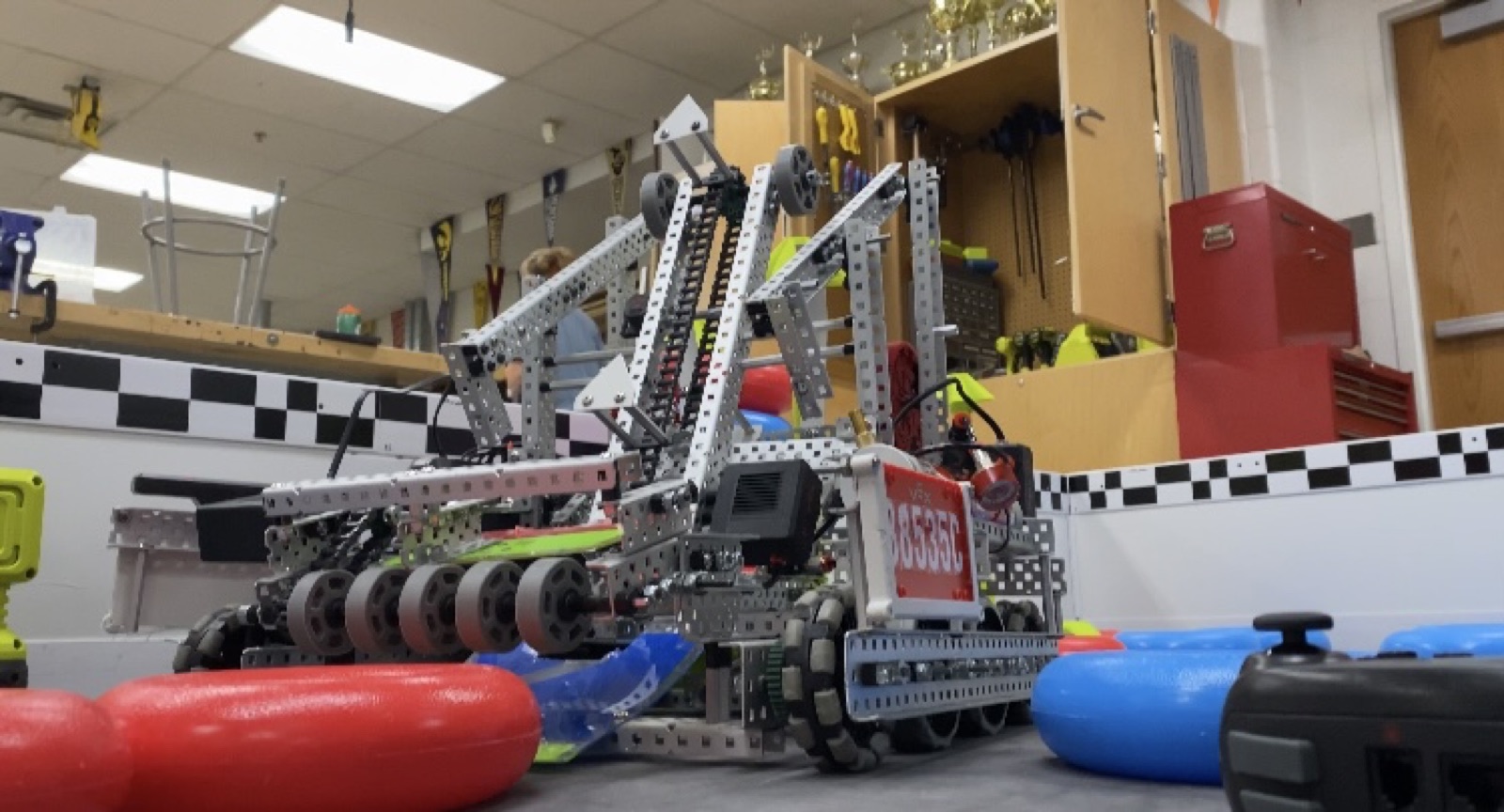 High Stakes Robot 1 on the practice field with the conveyor attached to the 4 bar lift