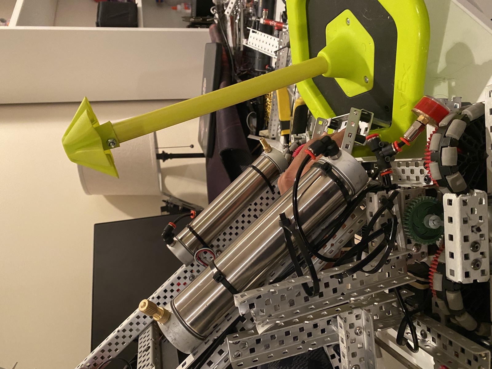 The clamp mounted at the back of the robot next to the tanks and drive base