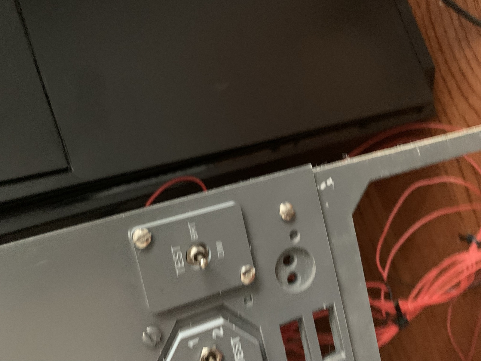 Close up of the TEST toggle between BRT and DIM on the back corner of the panel