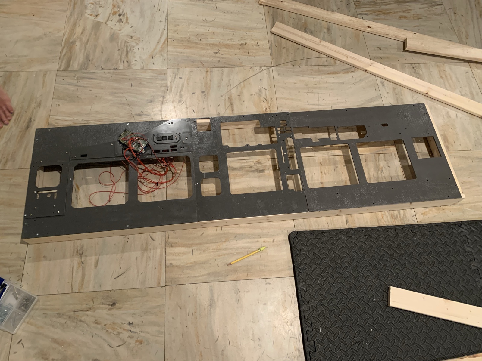 Full main instrument panel laid on the floor with display cutouts and early wiring