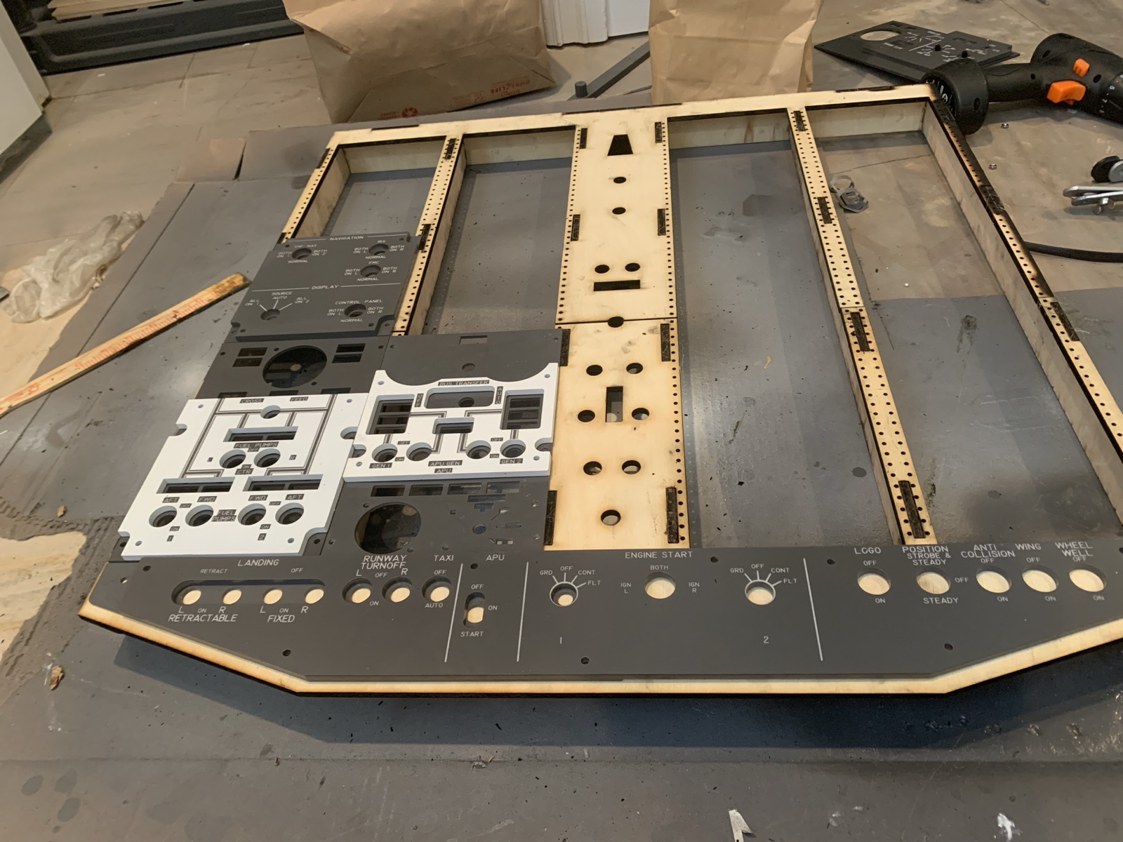 Assembled plywood overhead frame on the workbench with some panels test fitted into place