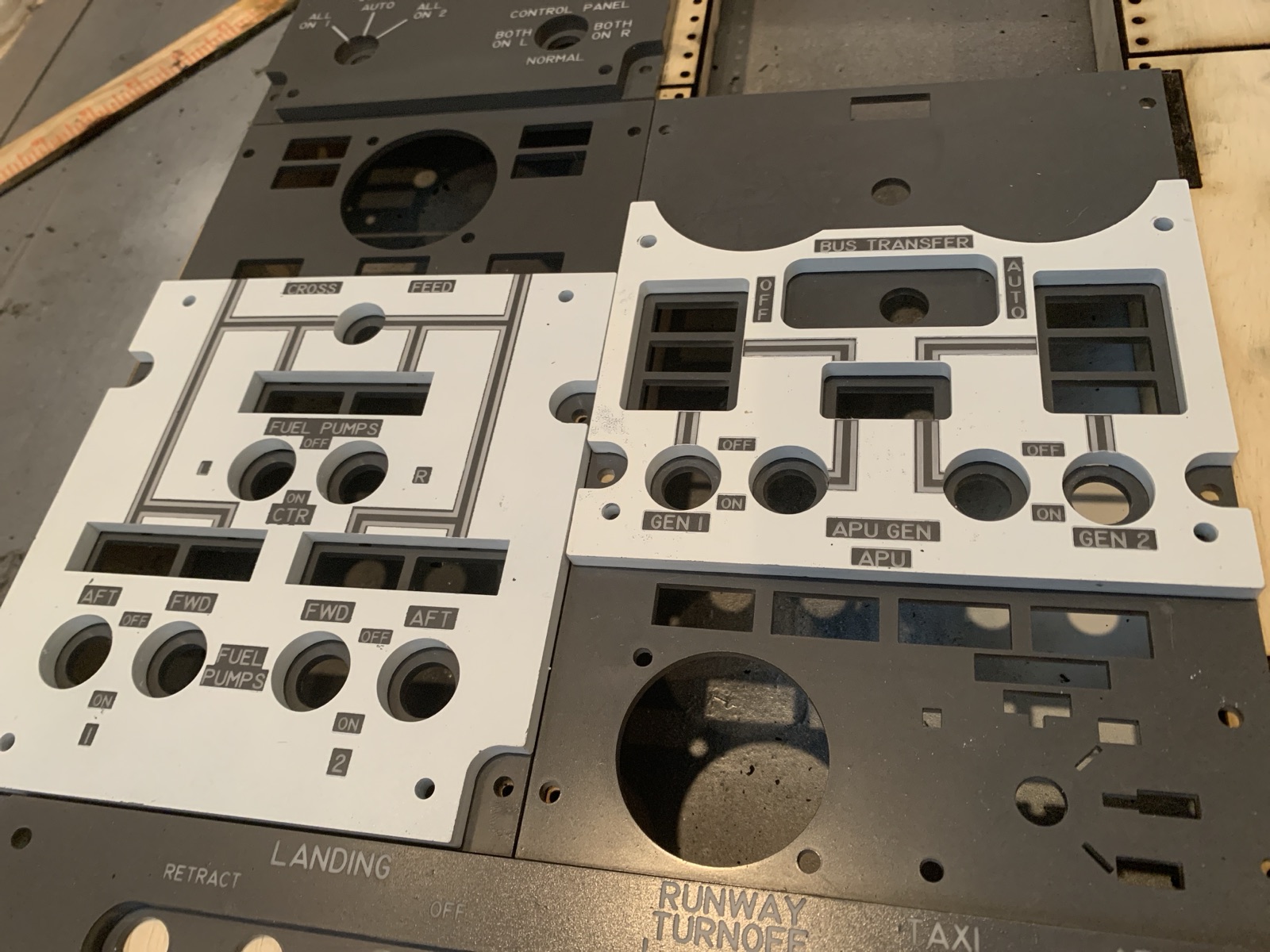 White fuel pump and bus transfer panels resting next to darker panels on the bench