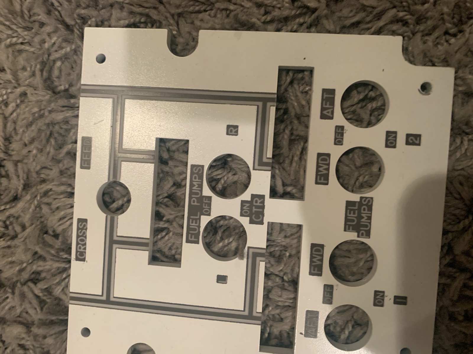 Additional overhead white panels showing engraved labels and cutouts