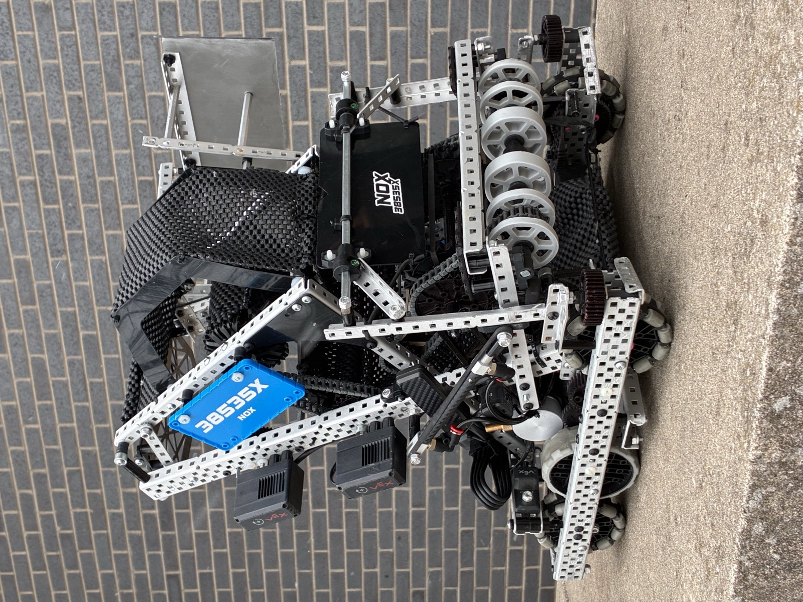 Build photo of the finished robot assembled with motors, battery, and carbon fiber vinyl wrap over the radio and pneumatics